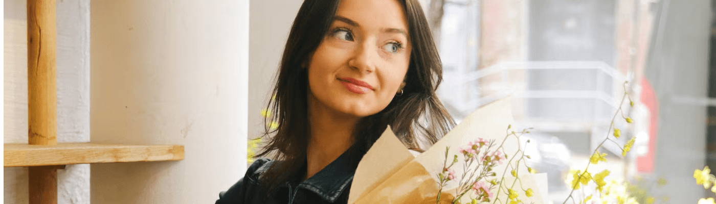 mini OI shampoo, OI milk, OI conditioner inside a packed suitcase