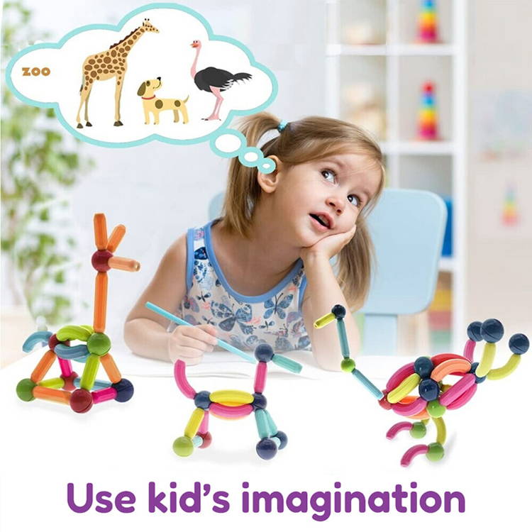 Little girl playing with her Montessori Magnetic Set and imagining different animals she could build using the pieces from the set. 