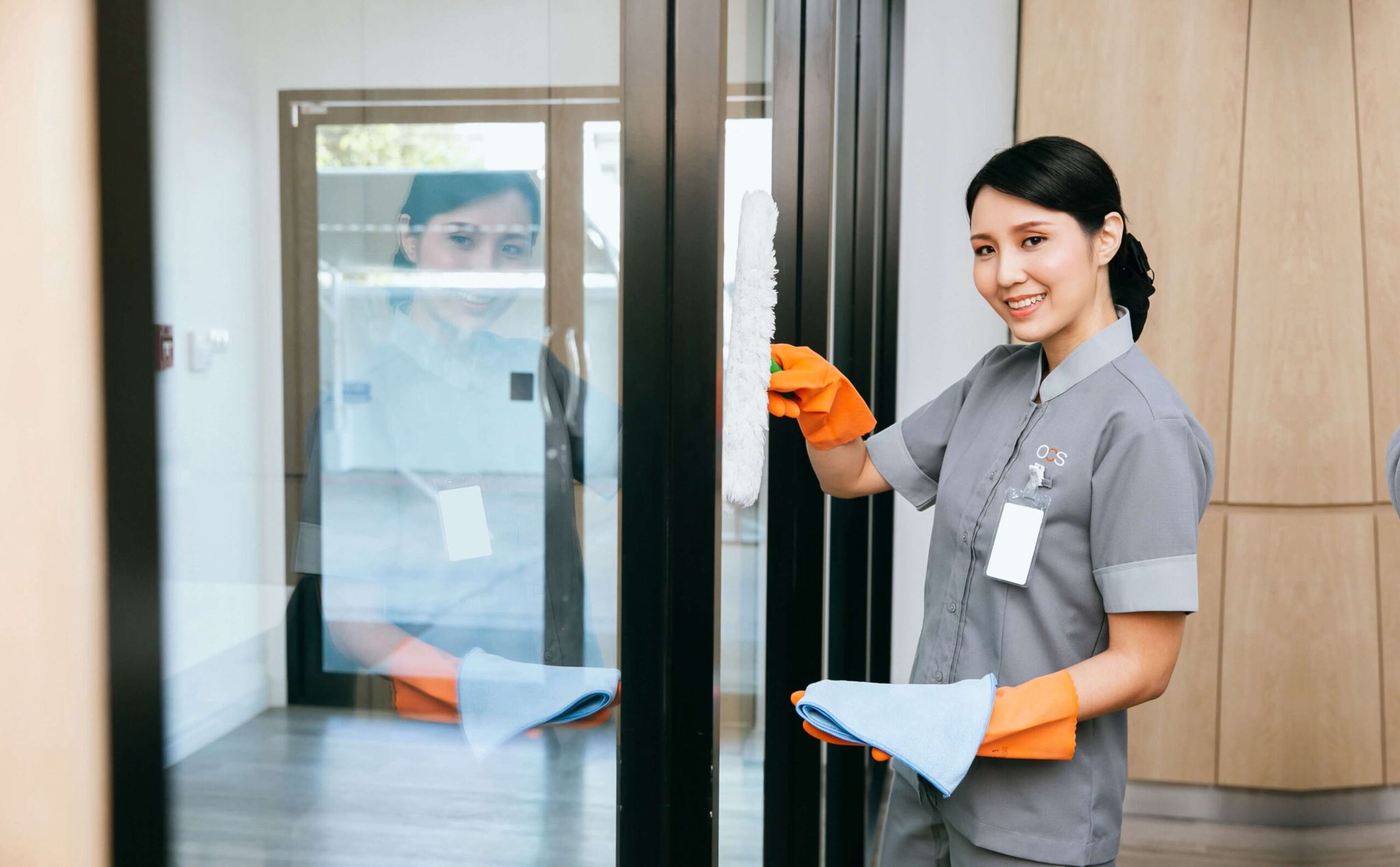 OCS colleague cleaning a window in uniform