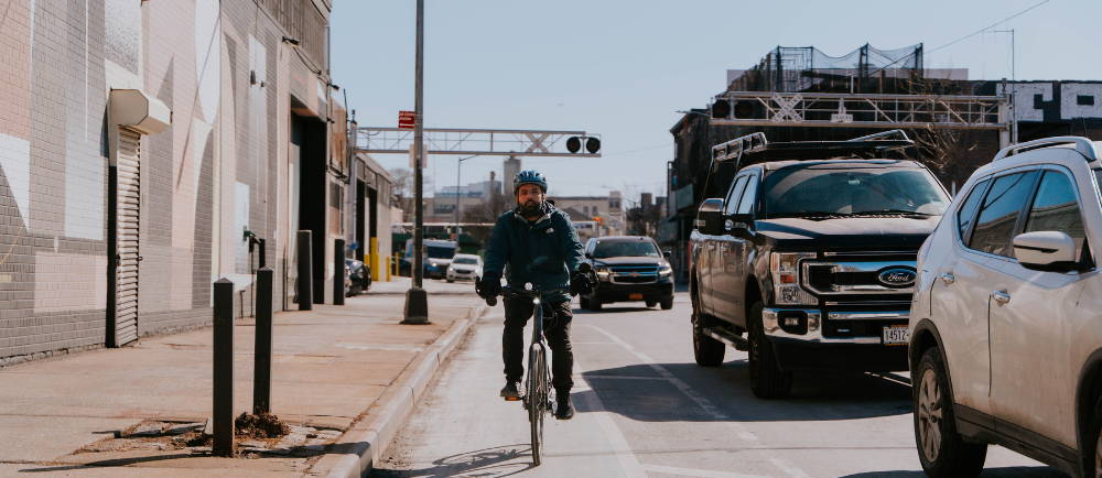 Rider on Momentum PakYak+ cargo bike on NYC bike lane