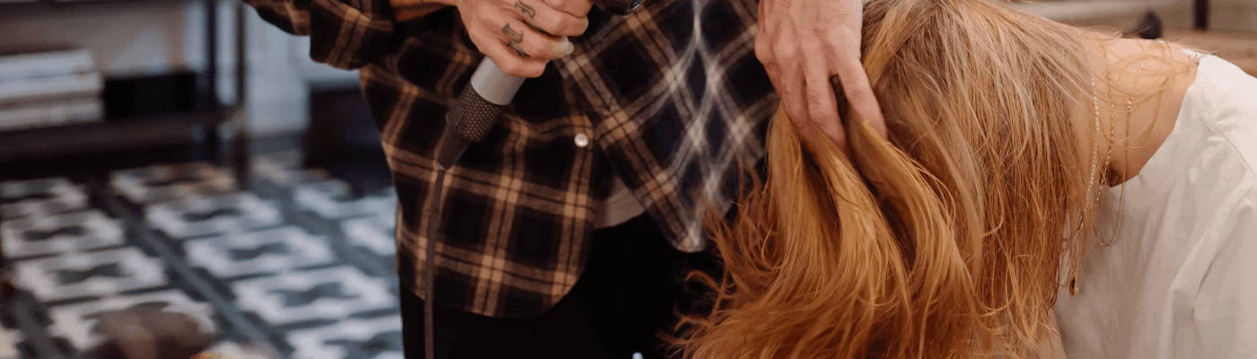 mini OI shampoo, OI milk, OI conditioner inside a packed suitcase