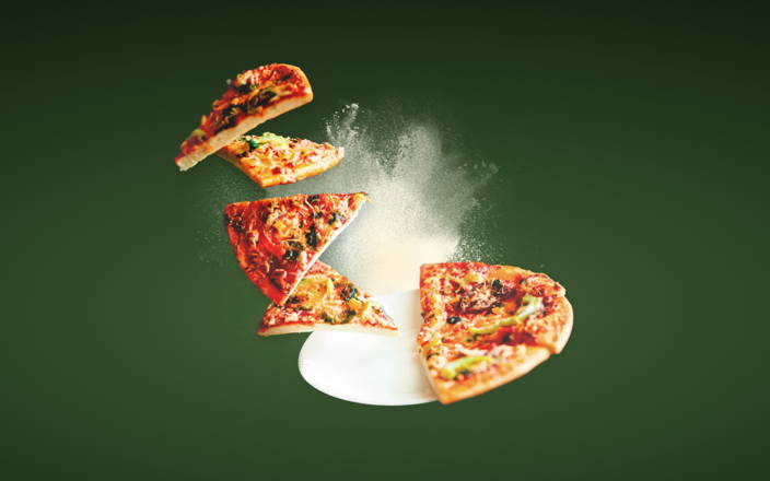 A pizza with half of the slices levitating above for Confetti's Pizza Making Class 