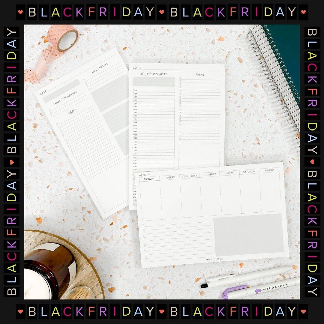 stack of amplify planner notepads with black friday frame