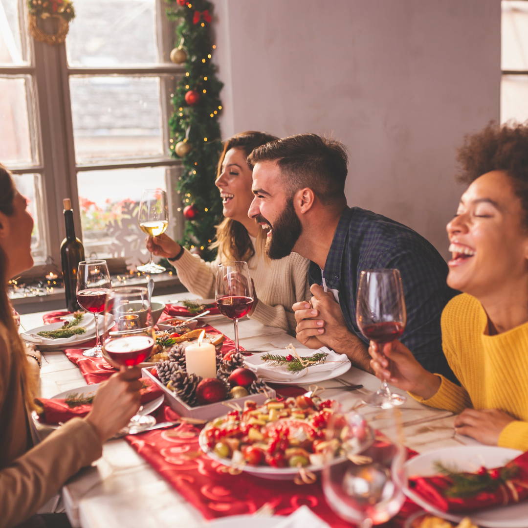 Luvbiotics Blog Image of Friends Smiling, enjoying Christmas Dinner