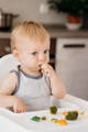 Baby putting a decoration on a birthday cake.