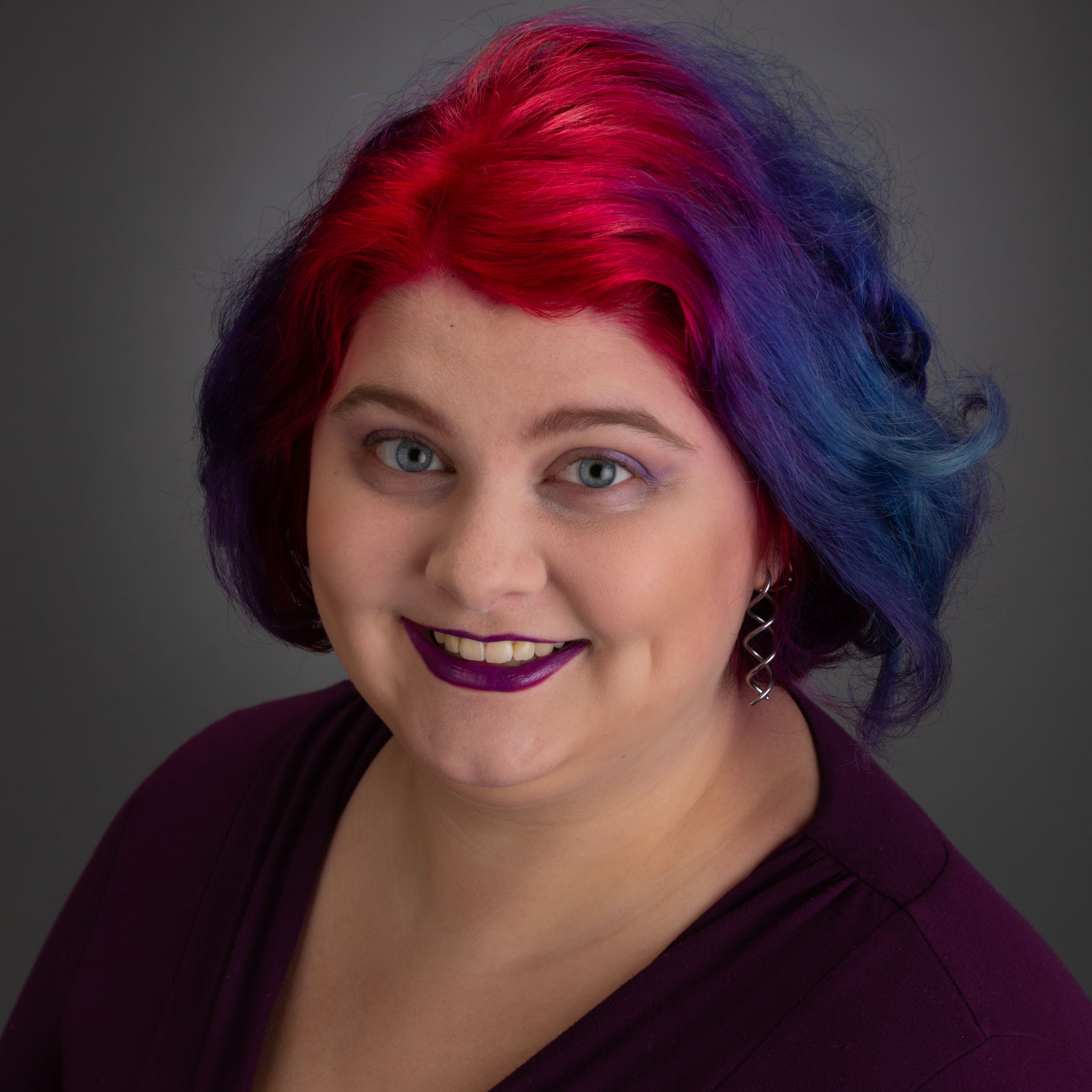 Portrait of Kaylee Walker smiling and rocking her multicolored bi hair.