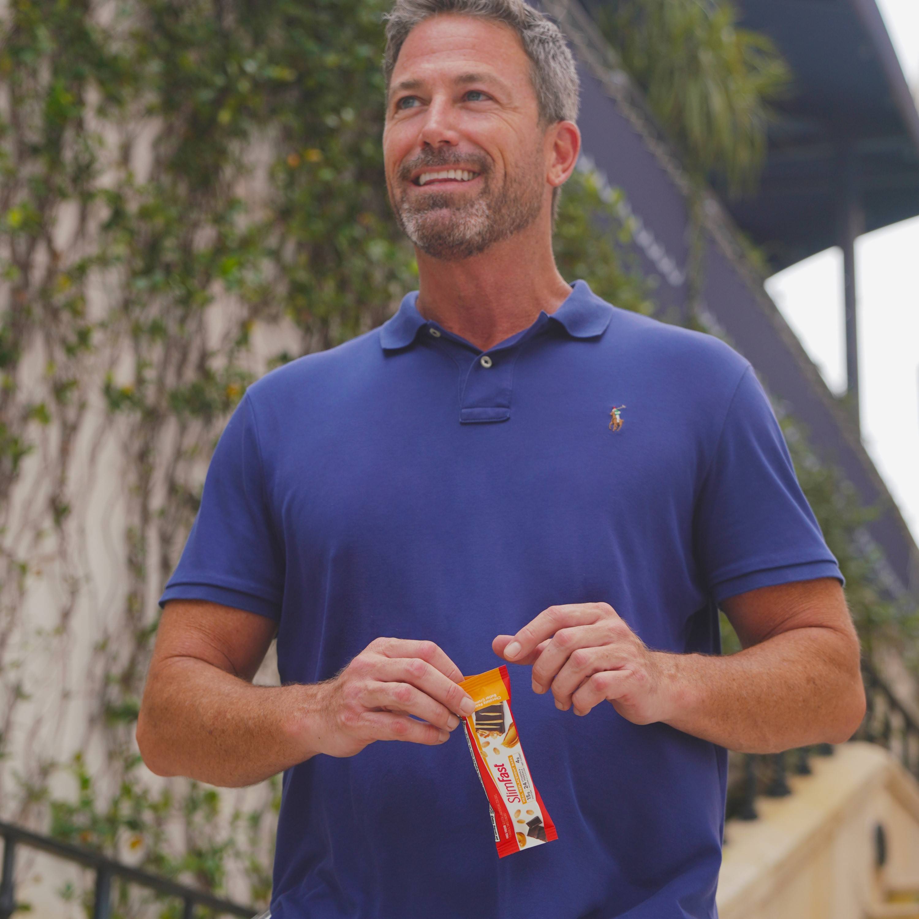 Man holding SlimFast meal bar