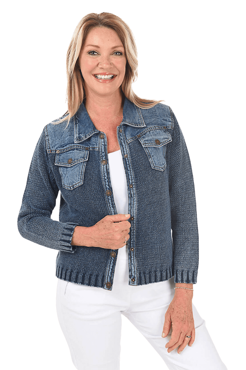 A woman wearing a blue denim sweater jacket and white pants