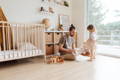 Father and his daughter playing together in a beautiful beige room. 