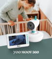 mother looking over her sleeping baby in a crib in a nursery with lots of lighting with babymoov yoo moov 360 video monitor in the front