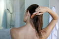 woman shot from back with damp hair and comb