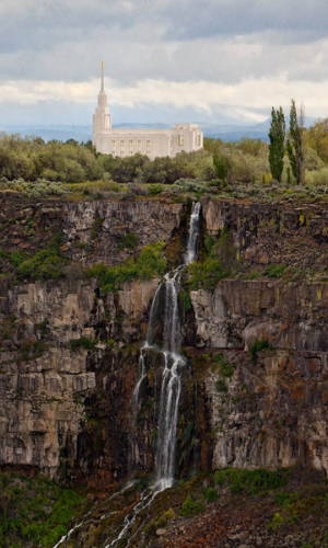 The Twin FAlls TEmple standing at the head of a steep waterfall.