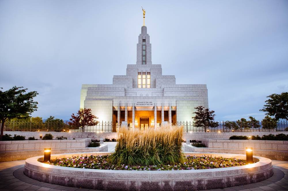Photo of Draper Utah LDS Temple with ground lights glowing.