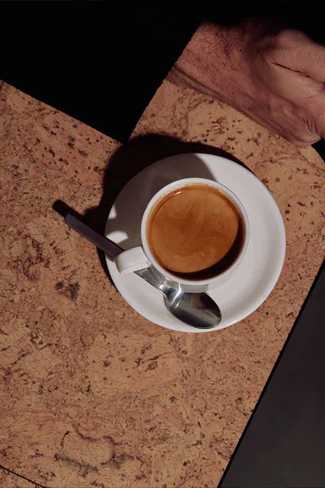 Espresso served on a saucer and spoon on a table 