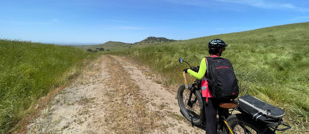 a female rider riding in spring in sierra foothills while on a tour with yosemite e-biking (yosemiteebiking.com)