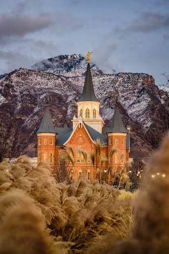 Provo City Center Temple standing behind an autumn field.