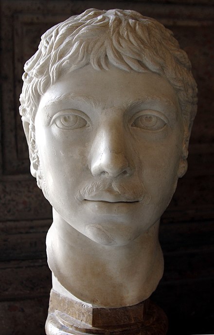 A marble bust of Elagabalus. She is depicted with a short hair, large eyes and a small mustache.