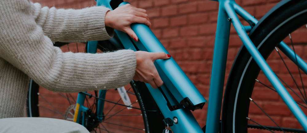 Rider taking out battery of Tenways electric bike