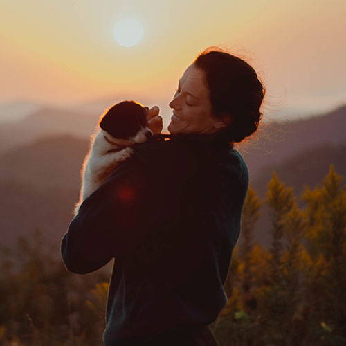 woman holding a border collie mix puppy