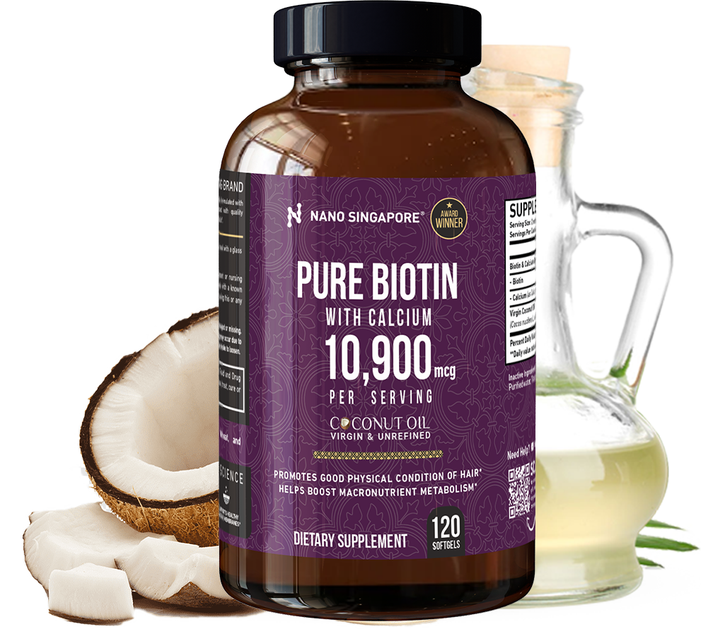 Bottle of NanoSingapore's best hair and skin supplements next to a coconut and bottle of oil