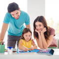 Mother and father watching their daughter drawing on a Montessori Magic Reusable Book. 