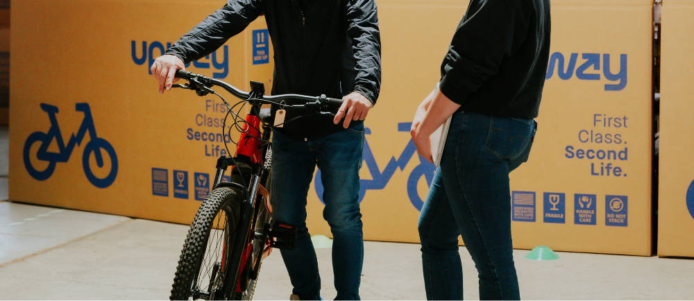 a rider bringing his Specialized mountain bike into the Upway warehouse