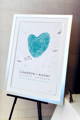 framed guest book poster with blue fingerprint heart and guest signatures