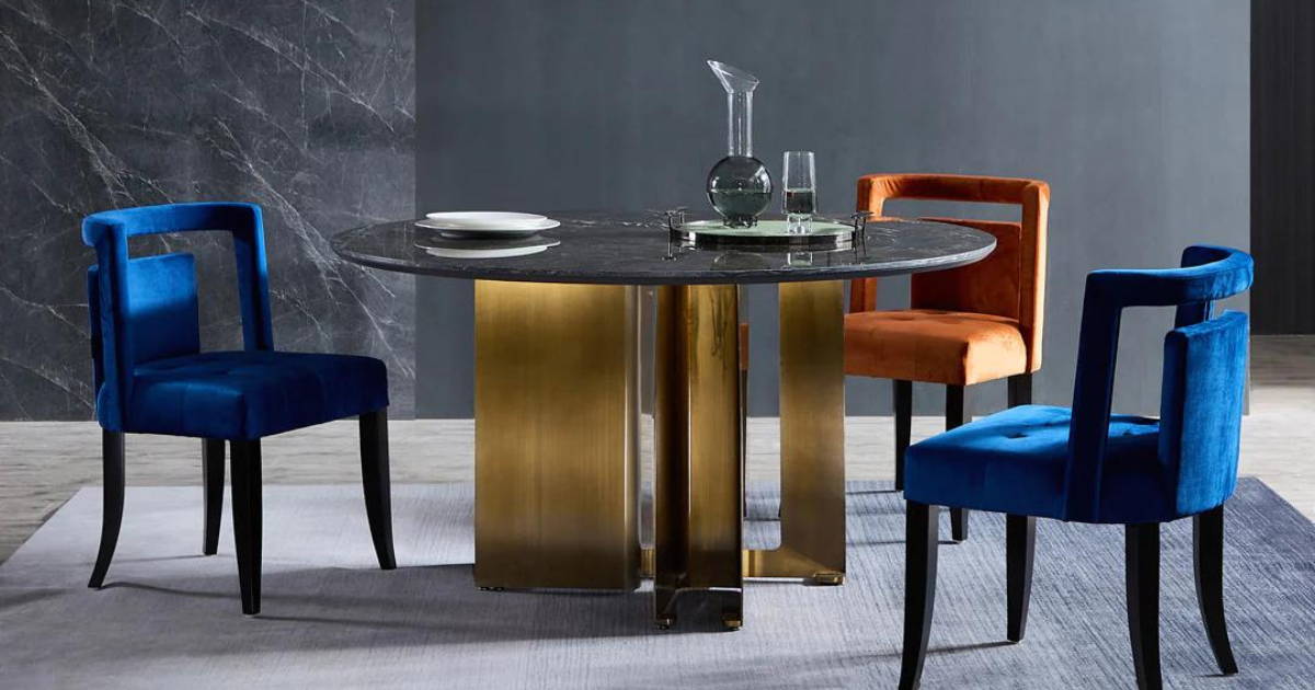 sintered stone top with brass legs and deep coloured dining chair