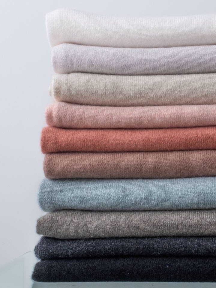A stack of cashmere Travel Wraps.