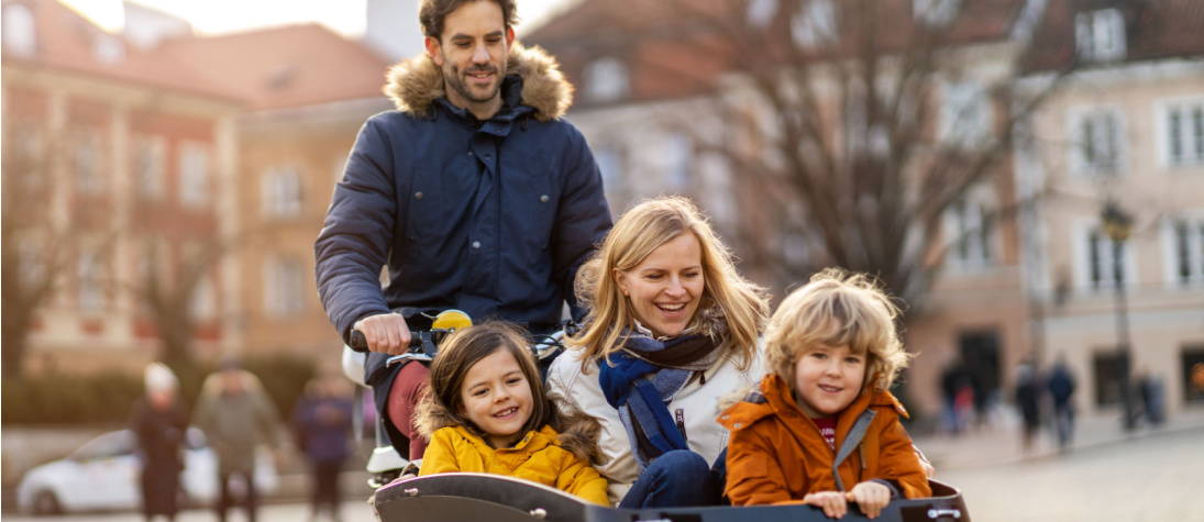 Family riding electric cargo bike