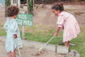 Two little girls gardening. 