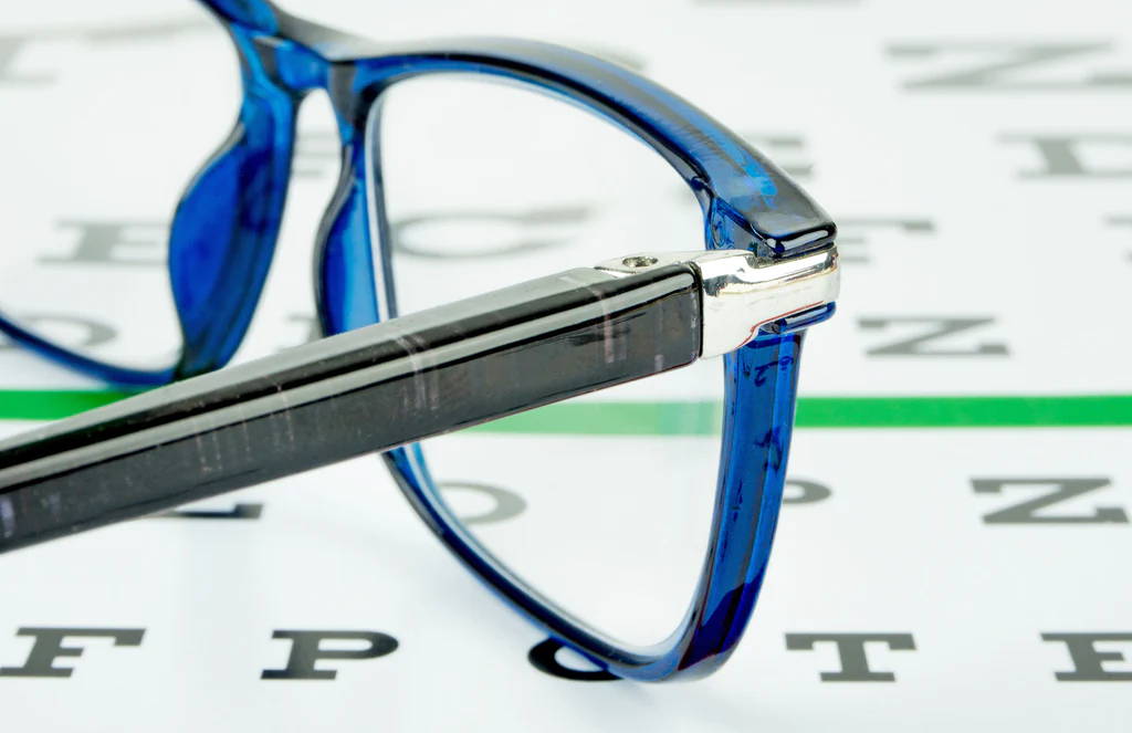 Glasses laying on an eye exam chart.