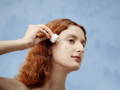 woman applying a serum