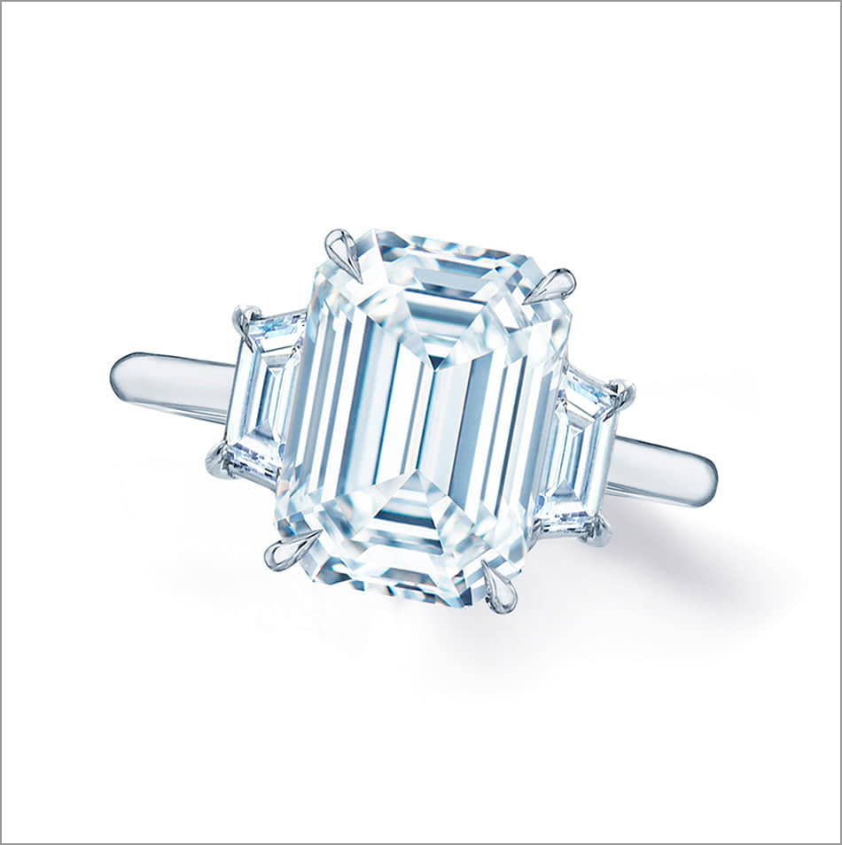 Top view of a three stone emerald cut diamond engagement ring.