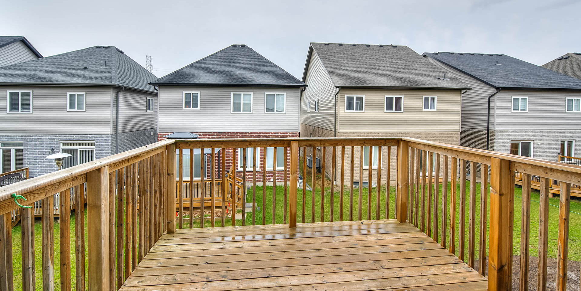 wooden terrace featuring a lawn