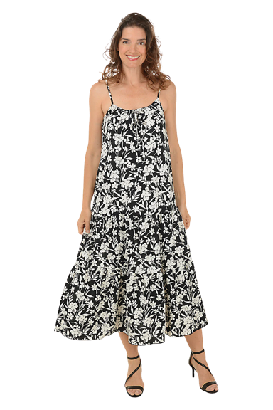 A woman wears a black and white wildflower sleeveless maxi dress.
