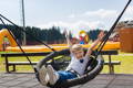 Kid swinging on a balance swing