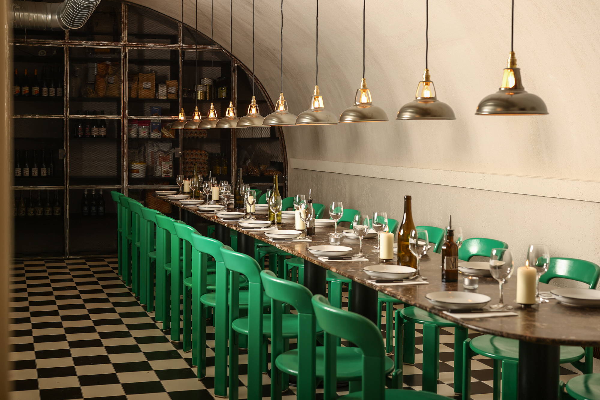 Coolicon Antinium lampshades hanging over a long set table inside a pasta resturaunt with a black and white checker board floor