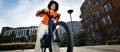 Woman standing over electric city bike