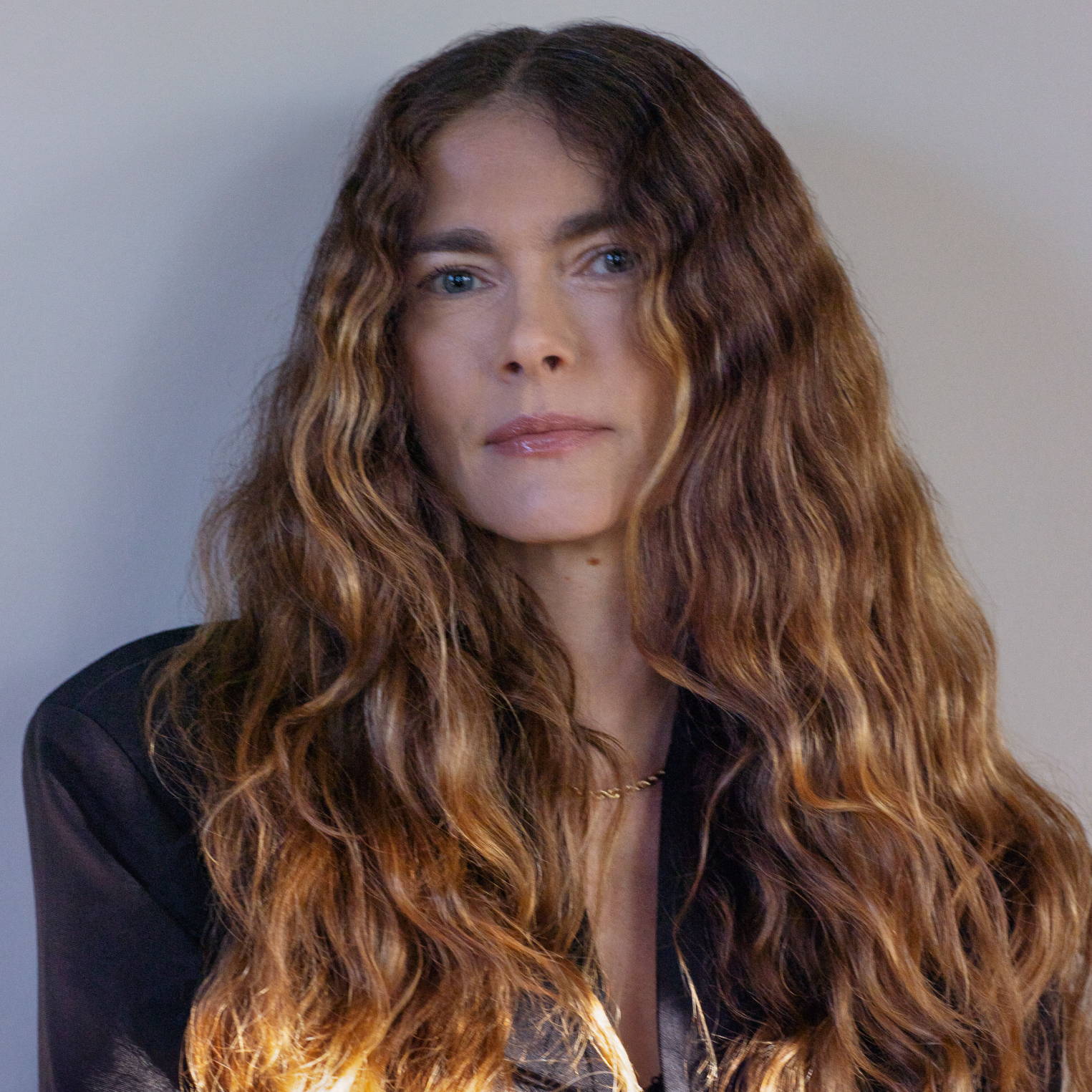 Davines model with long, wavy brown hair