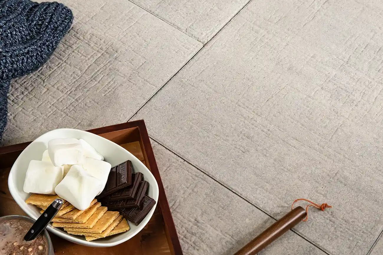 Close up of a patio made with Papyrus pavers with a charcuterie Board on it.