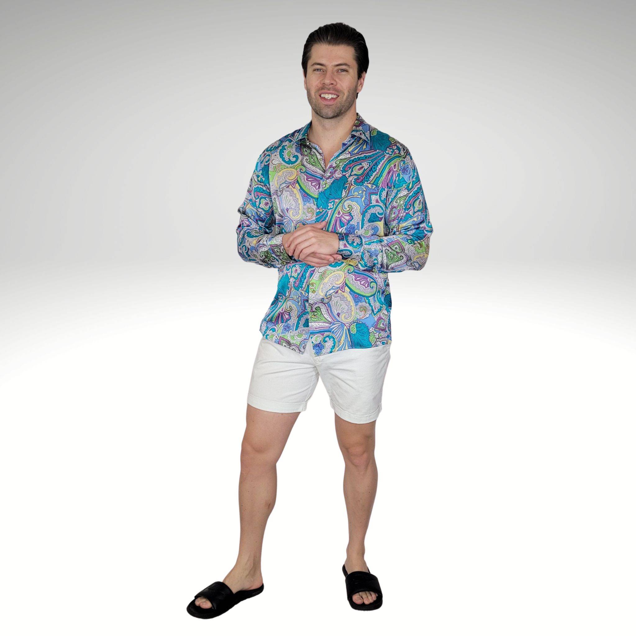 model wearing a multicolored Hawaii silk shirt with white shorts and black sandals