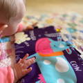Baby girl playing with the Montessori Soft Book.