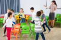 Children playing musical chairs game. 