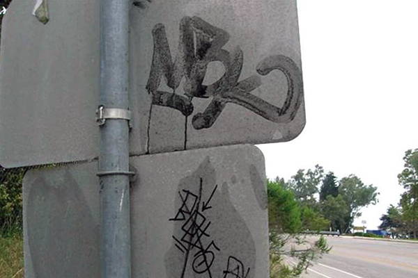 removing graffiti from back of street signs