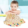 A boy looking at the camera with the Montessori Memory Match game on a table in front of him.