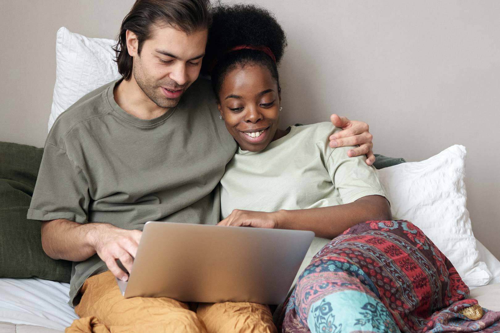 two adults looking at laptop