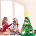 Brother, sister, and their mother adding decorations to Montessori 360 Christmas Tree. 