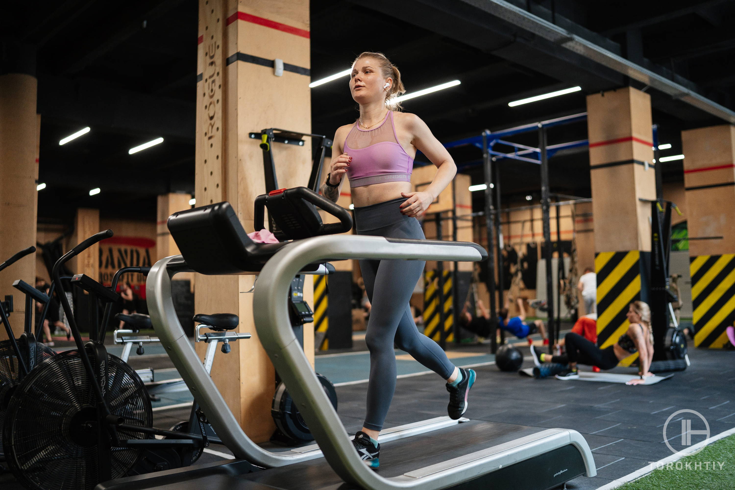 female athlete in pink top running on treadmill female athlete in pink top running on treadmill