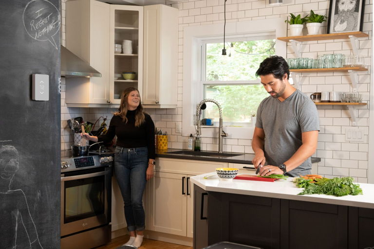 couple in kitchen controlled by multi zone thermostat